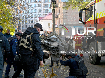 In Kyiv, Ukraine, on November 17, 2024, workers of the State Emergency Service and forensic experts examine part of a Russian missile that h...