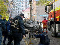 In Kyiv, Ukraine, on November 17, 2024, workers of the State Emergency Service and forensic experts examine part of a Russian missile that h...