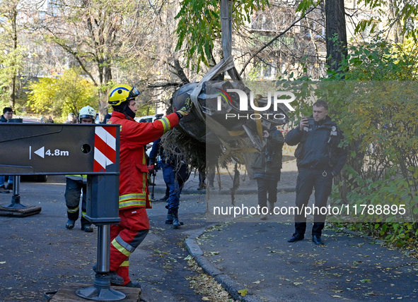 Workers of the State Emergency Service remove part of a Russian missile that hits a five-storey apartment building in the Pecherskyi distric...