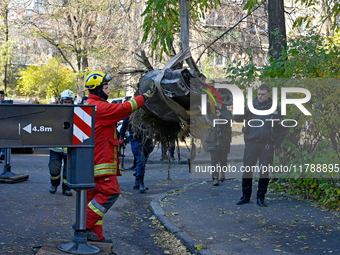 Workers of the State Emergency Service remove part of a Russian missile that hits a five-storey apartment building in the Pecherskyi distric...