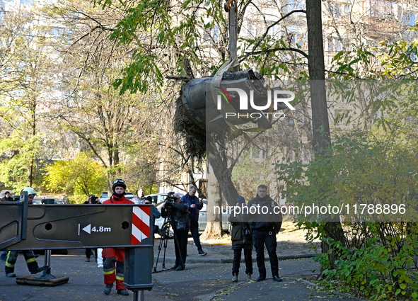 Workers of the State Emergency Service remove part of a Russian missile that hits a five-storey apartment building in the Pecherskyi distric...