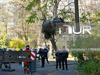 Workers of the State Emergency Service remove part of a Russian missile that hits a five-storey apartment building in the Pecherskyi distric...