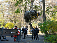 Workers of the State Emergency Service remove part of a Russian missile that hits a five-storey apartment building in the Pecherskyi distric...