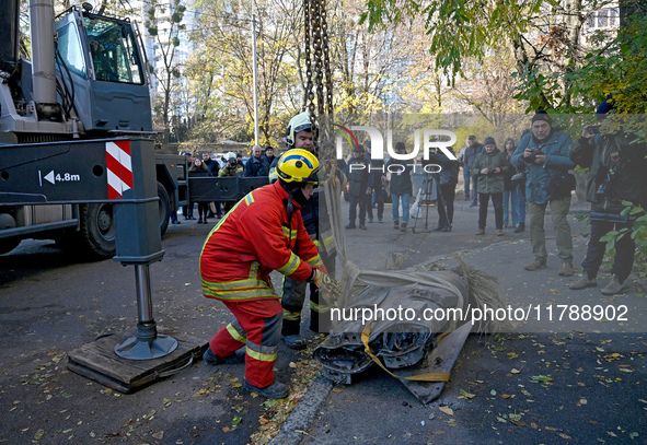 Workers of the State Emergency Service remove part of a Russian missile that hits a five-storey apartment building in the Pecherskyi distric...