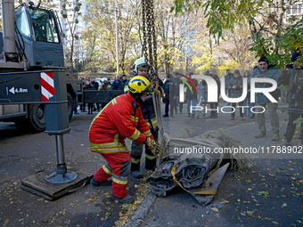 Workers of the State Emergency Service remove part of a Russian missile that hits a five-storey apartment building in the Pecherskyi distric...