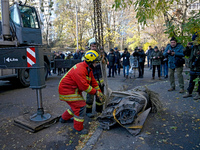 Workers of the State Emergency Service remove part of a Russian missile that hits a five-storey apartment building in the Pecherskyi distric...