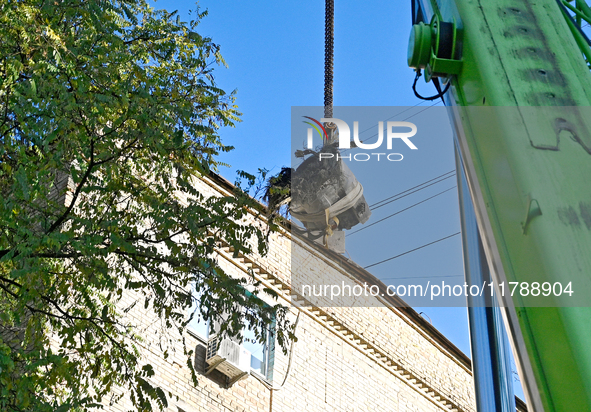 Workers of the State Emergency Service remove part of a Russian missile that hits a five-storey apartment building in the Pecherskyi distric...