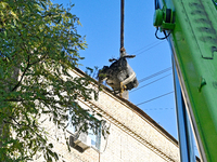 Workers of the State Emergency Service remove part of a Russian missile that hits a five-storey apartment building in the Pecherskyi distric...