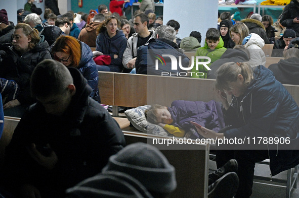 A child sleeps on a bench in a bomb shelter during an air alert caused by a large-scale Russian missile and drone attack in Kyiv, Ukraine, o...