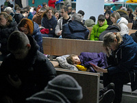 A child sleeps on a bench in a bomb shelter during an air alert caused by a large-scale Russian missile and drone attack in Kyiv, Ukraine, o...