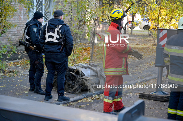 In Kyiv, Ukraine, on November 17, 2024, law enforcers stand by a fragment of a Russian missile removed from a five-storey apartment building...