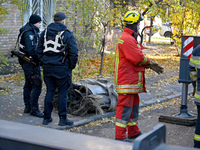 In Kyiv, Ukraine, on November 17, 2024, law enforcers stand by a fragment of a Russian missile removed from a five-storey apartment building...