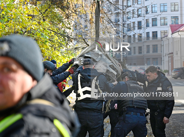 In Kyiv, Ukraine, on November 17, 2024, workers of the State Emergency Service and forensic experts examine part of a Russian missile that h...