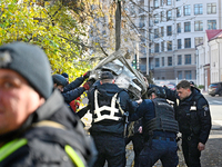 In Kyiv, Ukraine, on November 17, 2024, workers of the State Emergency Service and forensic experts examine part of a Russian missile that h...