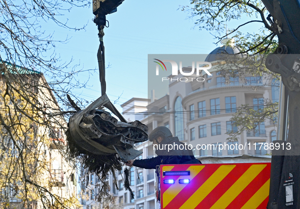 A State Emergency Service worker helps load a fragment of a Russian missile removed from a five-storey apartment building in the Pecherskyi...