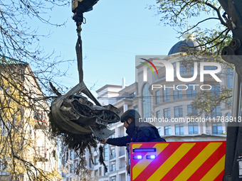 A State Emergency Service worker helps load a fragment of a Russian missile removed from a five-storey apartment building in the Pecherskyi...