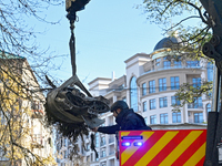 A State Emergency Service worker helps load a fragment of a Russian missile removed from a five-storey apartment building in the Pecherskyi...