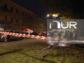 Emergency and rescue services stand by during a response effort to a fire in a three-story residential building caused by a Russian missile...