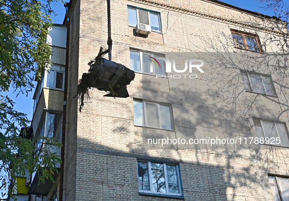 Workers of the State Emergency Service remove part of a Russian missile that hits a five-storey apartment building in the Pecherskyi distric...