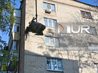 Workers of the State Emergency Service remove part of a Russian missile that hits a five-storey apartment building in the Pecherskyi distric...