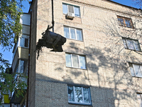 Workers of the State Emergency Service remove part of a Russian missile that hits a five-storey apartment building in the Pecherskyi distric...