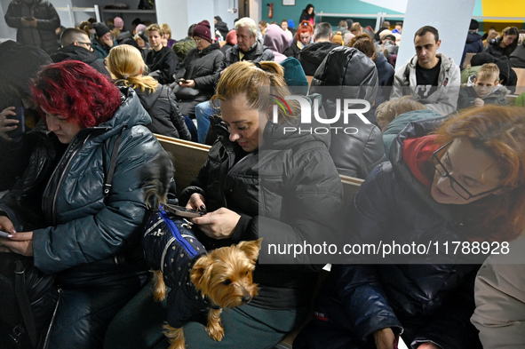 In Kyiv, Ukraine, on November 17, 2024, people with pets stay in a bomb shelter during an air alert caused by a large-scale Russian missile...