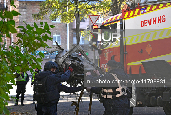 In Kyiv, Ukraine, on November 17, 2024, workers of the State Emergency Service and forensic experts examine part of a Russian missile that h...