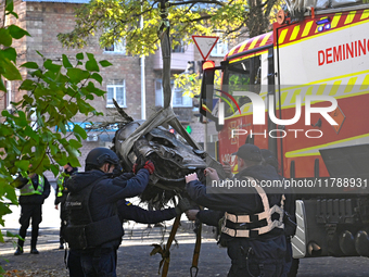 In Kyiv, Ukraine, on November 17, 2024, workers of the State Emergency Service and forensic experts examine part of a Russian missile that h...