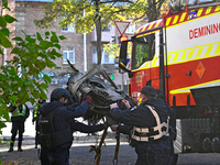 In Kyiv, Ukraine, on November 17, 2024, workers of the State Emergency Service and forensic experts examine part of a Russian missile that h...