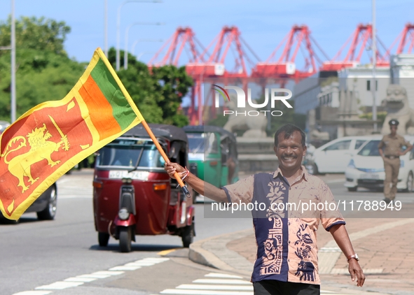 A supporter of Sri Lankan President Anura Kumara Dissanayake celebrates outside the president's office in Colombo, Sri Lanka, on November 18...