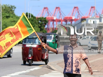 A supporter of Sri Lankan President Anura Kumara Dissanayake celebrates outside the president's office in Colombo, Sri Lanka, on November 18...