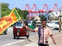 A supporter of Sri Lankan President Anura Kumara Dissanayake celebrates outside the president's office in Colombo, Sri Lanka, on November 18...