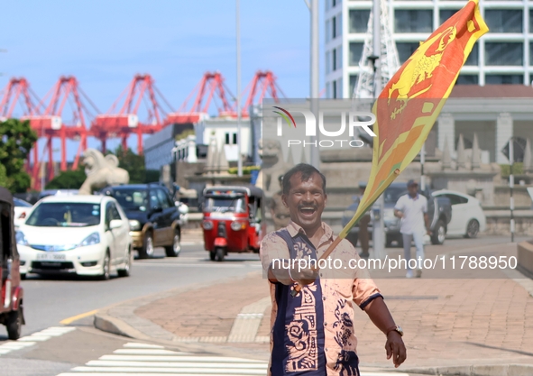 A supporter of Sri Lankan President Anura Kumara Dissanayake celebrates outside the president's office in Colombo, Sri Lanka, on November 18...