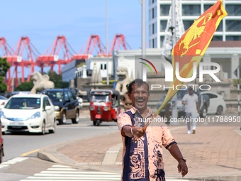 A supporter of Sri Lankan President Anura Kumara Dissanayake celebrates outside the president's office in Colombo, Sri Lanka, on November 18...