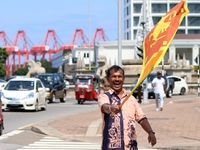 A supporter of Sri Lankan President Anura Kumara Dissanayake celebrates outside the president's office in Colombo, Sri Lanka, on November 18...