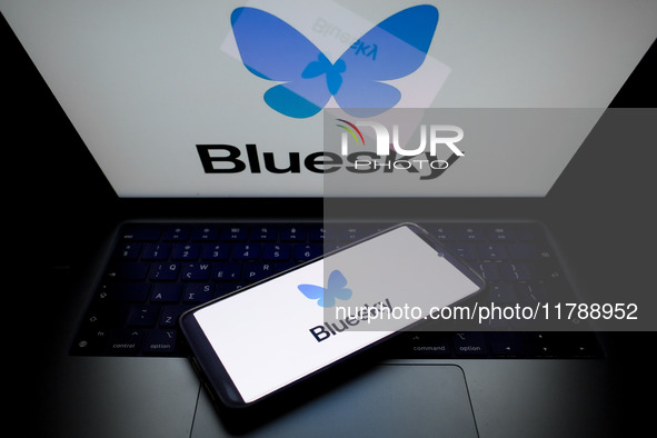 The Bluesky logo appears on a smartphone screen and as a background on a computer screen in this photo illustration in Athens, Greece, on No...