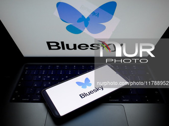 The Bluesky logo appears on a smartphone screen and as a background on a computer screen in this photo illustration in Athens, Greece, on No...