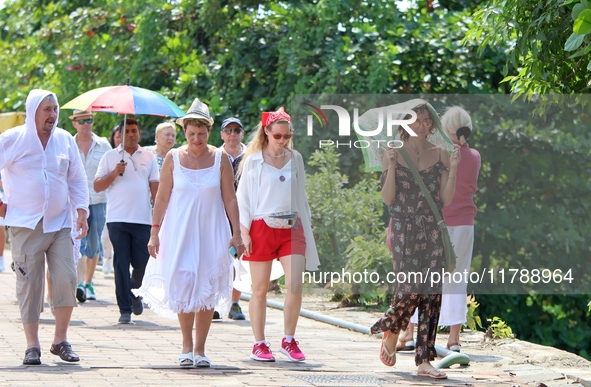 Tourists walk near Galle Face Green in Colombo, Sri Lanka, on November 18, 2024. 