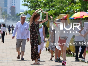 Tourists pose for a photograph near Galle Face Green in Colombo, Sri Lanka, on November 18, 2024. (