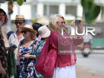 A tourist captures a photograph with her smartphone near Galle Face Green in Colombo, Sri Lanka, on November 18, 2024. (