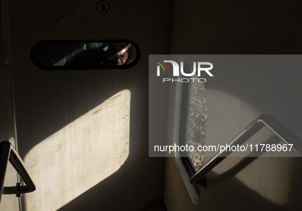 An Iranian woman sits on a train traveling in western Tehran, Iran, on November 17, 2024. 