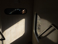 An Iranian woman sits on a train traveling in western Tehran, Iran, on November 17, 2024. (