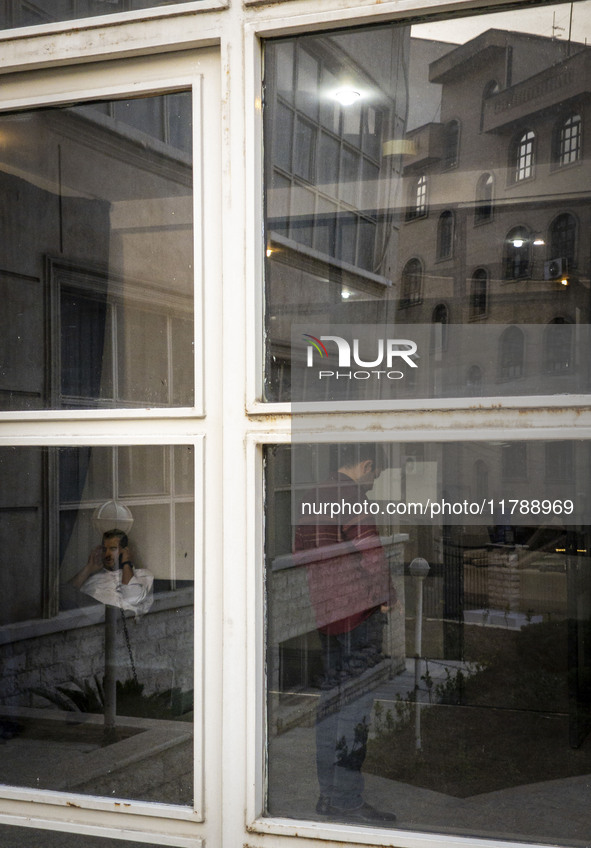 Two Iranian men are seen at a public library in downtown Tehran, Iran, on November 16, 2024. 