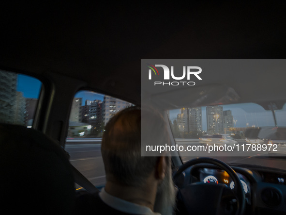 An Iranian Internet-taxi driver drives along an expressway in the Chigger neighborhood in northwestern Tehran, Iran, on November 17, 2024, a...