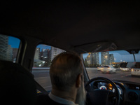 An Iranian Internet-taxi driver drives along an expressway in the Chigger neighborhood in northwestern Tehran, Iran, on November 17, 2024, a...