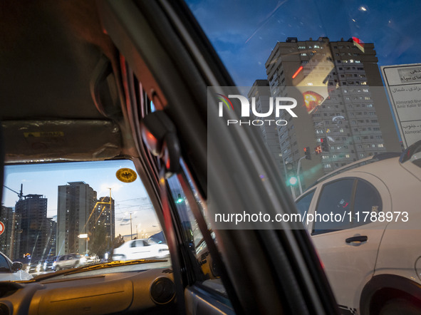 Vehicles stop on a road in a residential area in the Chigger neighborhood in northwestern Tehran, Iran, on November 17, 2024, at sunset. 