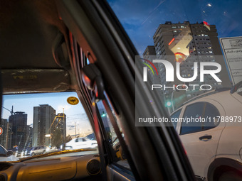 Vehicles stop on a road in a residential area in the Chigger neighborhood in northwestern Tehran, Iran, on November 17, 2024, at sunset. (