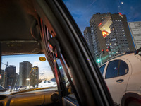 Vehicles stop on a road in a residential area in the Chigger neighborhood in northwestern Tehran, Iran, on November 17, 2024, at sunset. (