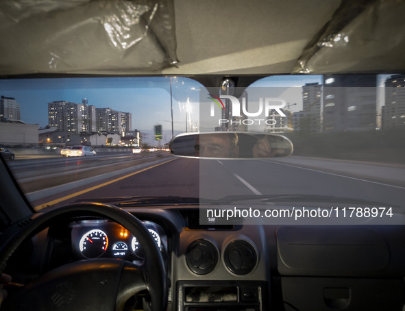 An Iranian Internet-taxi driver drives along an expressway in the Chigger neighborhood in northwestern Tehran, Iran, on November 17, 2024, a...