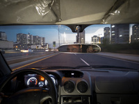 An Iranian Internet-taxi driver drives along an expressway in the Chigger neighborhood in northwestern Tehran, Iran, on November 17, 2024, a...